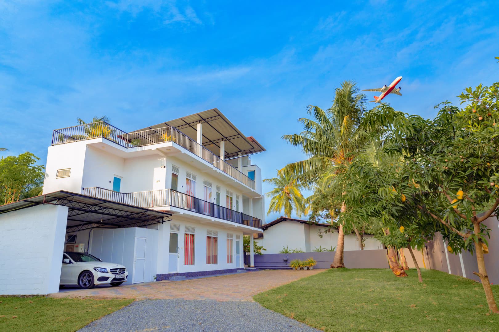 Lagoon Step Transit Hotel exterior by day with aircraft overhead